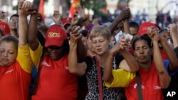 People pray during a demonstration in support of Venezuela's President Hugo Chavez at the Simon Bolivar Square in Caracas, Venezuela, Sunday, Dec. 9, 2012.