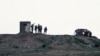 Fighters of People's Protection Units, or YPG, gather at their outpost west of the city of Kobani, northern Syria, Dec. 18, 2018.