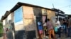 FILE - Residents of Cidade de Deus slum receive food from members of the Institute doAcao, which was produced at the Santuario de Nossa Senhora de Fatima, amid the COVID-19 outbreak, in Rio de Janeiro, Brazil, June 24, 2021.
