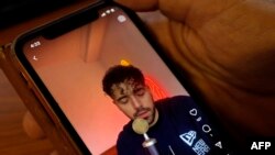 FILE - A video of Iranian singer Shervin Hajipour plays on a phone in Nicosia, Cyprus, Oct. 4, 2022. 