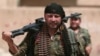 FILE - A Kurdish fighter from the People's Protection Units (YPG) carries his weapons as he walks the streets in the northeastern city of Hasaka, Syria, Aug. 21, 2016.