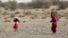 FILE - Yemenis displaced by conflict receive food aid and provisions to meet their basic needs at a camp in the Khokha district of Yemen's war-ravaged western province of Hodeida, Jan. 31, 2022. 