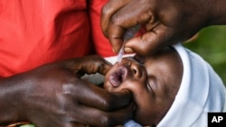 A baby receives a polio vaccine during the Malawi Polio Vaccination Campaign Launch, in Lilongwe Malawi, Sunday March 20, 2022. A drive to vaccinate more than 9 million children against polio has been launched this week in four countries in southern and e