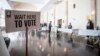 FILE - Polling location workers await a rush of lunchtime voters in the U.S. Senate runoff election, Dec. 6, 2022, in Atlanta. 
