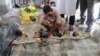 Shuna Miya cries over bodies of his daughters, before their bodies are taken for the funeral just behind Inani Beach near Cox's Bazar, Bangladesh, Sept. 29, 2017. 