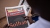 A man reads the 'L'Observateur Paalga' newspaper in Ouagadougou on June 7, 2021, about the attacks in Solhan, a village in Burkina Faso's volatile north.
