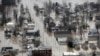 FILE - Homes are surrounded by floodwater Dec. 30, 2015, in Pacific, Mo. Global warming is partly to blame for the weather extremes, experts say.
