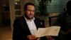 Libyan dissident Abdel Hakim Belhaj holds a letter of apology he received from British Prime Minister Theresa May, following a news conference in Istanbul, Turkey, May 10, 2018.