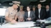 In this image from the Taiwan Presidential Office, Taiwan's President Tsai Ing-wen (center) reviews nautical charts aboard a Taiwan Navy ship before it sets out to patrol in the South China Sea from the naval base in the southern port city of Khaohsiung, Taiwan.