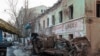 FILE - Municipal workers remove debris at a site of a Russian missile strike, amid Russia's attack on Ukraine, in central Kharkiv, Ukraine, Jan. 17, 2024.