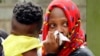 Relatives grieve after learning a loved one was killed in an attack on an upscale hotel compound, in Nairobi, Kenya, Jan. 16, 2019.