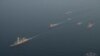 Military vessels escort tugboats as they sail toward the damaged oil tanker Sounion, which has been on fire since Aug. 23, after an attack by Houthi militants, on the Red Sea, Sept. 14, 2024. (Eunavfor Aspides via Reuters)