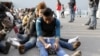 Migrants rest after disembarking from the British assault ship HMS Bulwark at the Sicilian port of Catania after being rescued at sea, Italy, June 8, 2015.