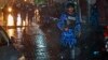 A Maldives policeman charges with a baton towards protesters after the government declared a state of emergency, in Male, Maldives, early Tuesday, Feb. 6, 2018. 