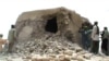 FILE - This file photo taken on July 1, 2012 shows a still from a video of Islamist militants destroying an ancient shrine in Timbuktu. The trial of a Malian jihadist charged with war crimes for ordering the 2012 destruction of 14 mausoleums of Muslim sai