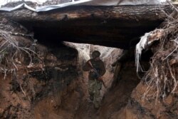A Ukrainian serviceman patrols along a position at the front line with Russia-backed separatists not far from Avdiivka, Donetsk region, April 5, 2021.