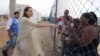 FILE - Angelina Jolie greets a group of Venezuelan migrants at a United Nations-run camp in Maicao, Colombia, on the border with Venezuela, June 8, 2019.