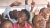Haitian worshipers chat during outdoor services.