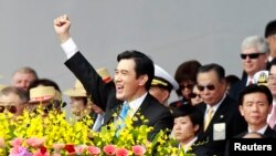 FILE - Taiwan's President Ma Ying-jeou raises his fist after giving a speech during National Day celebrations in front of the presidential office in Taipei, Oct. 10, 2013.
