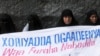 FILE - Ogaden National Liberation Front activists hold a banner in Mogadishu that reads, "The Ogaden freedom is the key to peace in the Horn of Africa," during a ceremony that marked the organization's 22nd anniversary in Somalia, Aug. 15, 2006.