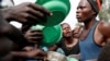 Internally displaced people wait for food distribution at an internally displaced persons (IDP) camp in Bunia, Ituri province, eastern Democratic Republic of Congo, April 12, 2018. 