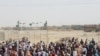 People gather and wait to welcome their relatives arriving from Afghanistan, at the Friendship Gate crossing point at the Pakistan-Afghanistan border town of Chaman, Pakistan, Aug. 17, 2021.