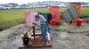 FILE - A Rohingya refugee man collects water from a tube-well near to a toilet in Cox's Bazar, Bangladesh, Nov. 15, 2017.