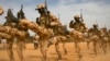 FILE - Chadian soldiers march during Flintlock 2014, a U.S.-led training mission for African militaries, in Diffa, Niger, March 3, 2014. The ruling junta in Niger has revoked an accord governing the roughly 1,000 U.S. military personnel there, the Pentagon said March 18, 2024.