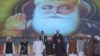 Indian Vice President M. Venkaiah Naidu, third left, stands for the national anthem during the foundation stone-laying ceremony for the planned road corridor to the Pakistan border, at Dera Baba Nanak, Nov. 26, 2018. 