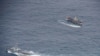 Ecuadorian Navy vessels surround a fishing boat after detecting a fishing fleet of mostly Chinese-flagged ships in an international corridor that borders the Galapagos Islands' exclusive economic zone, in the Pacific Ocean, August 7, 2020. Picture taken…