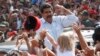 Venezuela's interim President Nicolas Maduro gestures to supporters as he leaves a polling station after voting in the presidential election in Caracas, Venezuela, Sunday, Apr. 14, 2013. 