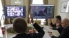 FILE - Members of the city commission to prevent the spread of coronavirus disease vote during a meeting via Zoom video link in Lviv, Ukraine, March 26, 2020. 