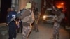 Masked Turkish police officers secure the perimeter outside a house during an operation to arrest people for alleged links to Islamic State group in Adana, Turkey, Nov. 10, 2017. 