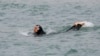 A Muslim woman wears a burkini, a swimsuit that leaves only the face, hands and feet exposed, as she swims in the Mediterranean Sea in Marseille, France, Aug. 17, 2016. 