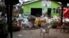 FILE - Damaged chairs and tables lie among the debris strewn after a bomb attack outside an Ethiopian restaurant in Kampala, Uganda, July 12, 2010.