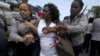 FILE - Berta Soler, leader of The Ladies in White, an opposition group, is detained by Cuban security personnel after a weekly anti-government protest march, in Havana, Sept. 13, 2015.