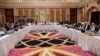 This photo released by Qatar's Ministry of Foreign Affairs shows Qatari, U.S. and Taliban officials conferring in an undisclosed place in Doha, Feb. 25, 2019, ahead of the latest round of talks with the insurgents aimed at ending the Afghan war.