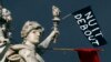 A red flag and a black one reading "Nuit Debout" (Rise up at Night) are seen on the place de la Republique in Paris, France, during social media-driven movement against the French labor law proposal, April 8, 2016. 