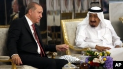 FILE - Turkey's President Recep Tayyip Erdogan, left, meets with Saudi King Salman, right, in Jiddah, Saudi Arabia, July, 23, 2017.