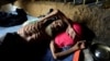 A Rohingya refugee man lies at his shelter in Kutupalong refugees camp in Cox's Bazar, Bangladesh, Oct. 20, 2017.