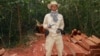 In this photo taken Feburary 6, 2012 and released by The Cambodian Center for Human Rights (CCHR), Chut Wutty stands on wooden planks of log in a jungle in Kampong Thom province in northern of Phnom Penh, Cambodia.