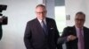 FILE - Former Donald Trump campaign official, later a Department of Health and Human Services spokesperson, Michael Caputo, left, leaves after being interviewed by a Senate committee, on Capitol Hill in Washington, May 1, 2018. 