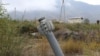An unexploded projectile of multiple rocket launcher stuck into land near a settlement in self-proclaimed Republic of Nagorno-Karabakh, Azerbaijan, Oct. 1, 2020.