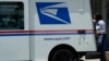 FILE - A U.S. Postal Service employee makes deliveries in Northbrook, Ill., June 3, 2024. Election officials across the U.S. are warning that problems with mail delivery threaten to disenfranchise voters in the upcoming presidential election. 