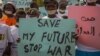 FILE - Women from more than forty South Sudanese womens organizations carry placards as march through Juba to express the frustration and suffering that women and children have endured after years of conflict, in Juba, South Sudan on Dec. 9, 2017. 