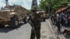 FILE - A Kenyan police officer part of a UN-backed multinational force gestures for journalists to move in Port-au-Prince, Haiti, July 17, 2024. 