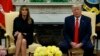 First lady Melania Trump listens as President Donald Trump talks about a plan to ban most flavored e-cigarettes, in the Oval Office of the White House, Sept. 11, 2019, in Washington.