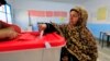 A Tunisian woman casts her ballot in the capital Tunis, Dec. 21, 2014. 