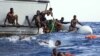 Sea-Watch, migrants from a sinking inflatable a Libyan coast guard ship during a rescue