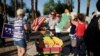 FILE - People protest, Aug. 4, 2020, in Las Vegas against a law signed this week by Nevada Gov. Steve Sisolak to mail ballots to all of the state's active voters ahead of the November election. 